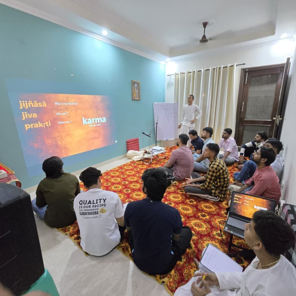 BACE Vedic philosophy class with students engaged in learning, Sanskrit concepts projected on screen