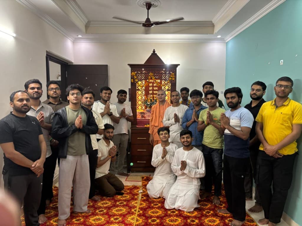 BACE community group photo before the altar - devotees gathered in prayerful anjali